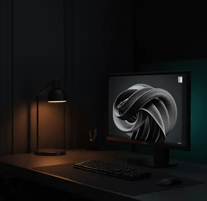 Dark modern designer workspace with a black desk setup, glowing monitor displaying abstract artwork, and cinematic lighting creating a premium creative studio atmosphere.